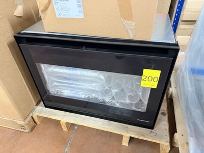 a microwave that is sitting on a pallet in a warehouse