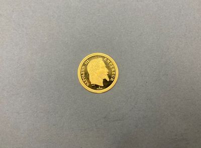 gros plan d'une pièce d'or sur laquelle figure le visage d'un homme