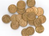 a pile of gold coins sitting on a white surface
