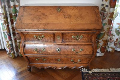 a wooden desk with drawers and a rug on the floor