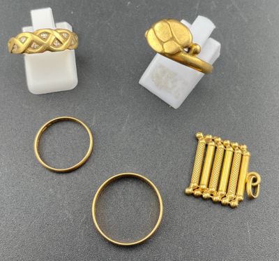 three gold rings, a ring, and a ring with a cross on it