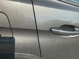 a car that has a broken door handle on the side of the road