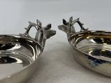 pair of silver plated bowls with handles and handles with birds on them