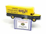 a yellow and black truck that is next to a box of food