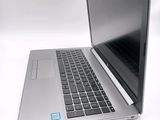 a laptop that is open on a white surface