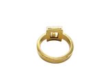 a close up of a gold ring on a white background