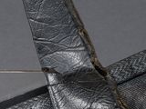 a piece of black leather that has been torn off