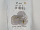 a close up of a bag of herbs on a white surface