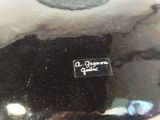 a black and white plate with a black cat on it