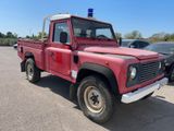 a red truck that is parked in a parking lot