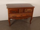 a small chest of drawers on a table in a room