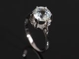 a close up of a diamond ring on a black surface