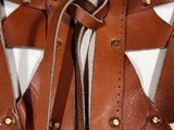 a close up of a brown leather vest on a mannequin mannequin