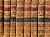 many books that are lined up on a shelf