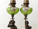 pair of antique bronze and green glass lamps with figures on them