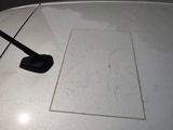 a piece of paper on the hood of a car