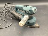 a corded sander and a corded sander on a table