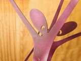 a metal sculpture of a person holding a knife