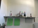 a counter that has a bunch of bottles on top of it