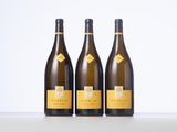 three bottles of wine sitting on top of a table next to each other