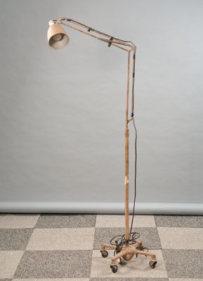 an image of a lamp that is on a stand on a checkered floor