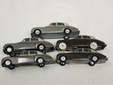 six toy cars sitting on top of each other on a white surface