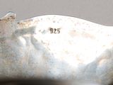 a close up of a silver spoon with a number on it