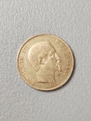 a close up of a gold coin with a man ' s face on it