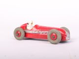 a red toy car with a teddy bear in it