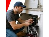 a man that is fixing a sink in the kitchen