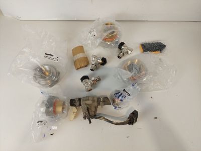 a lot of different types of valves and fittings on the table