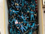 a box full of toy soldiers sitting on a table