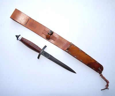 a knife that is laying on the table next to a knife