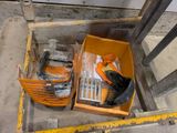 a box of tools sitting on the floor next to a pair of shoes