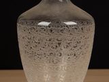 a glass vase that is sitting on a table
