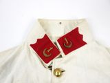 a close up of a white shirt with red and gold buttons