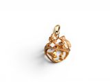 a gold plated charm with a bird on it