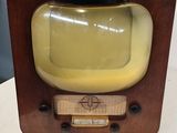 a small television sitting on a table with a yellow screen