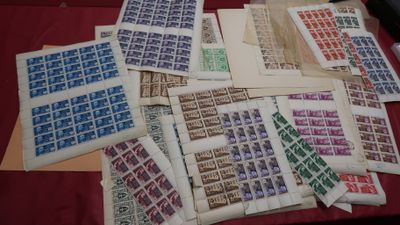 a lot of stamps on a table with a red table cloth
