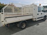 a white truck that has a cage on the back of it