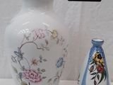 two vases sitting next to each other on a table