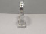 clear acrylic ring holder on a white surface