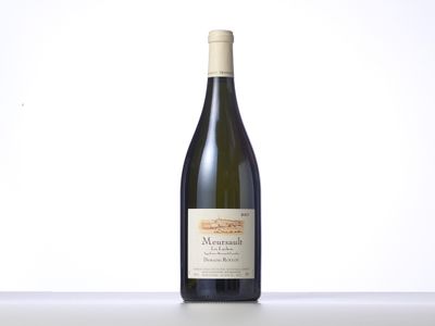 a bottle of wine sitting on top of a white table
