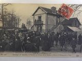an old photo of a group of people standing in front of a building