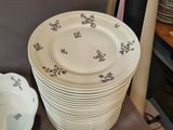 many plates and bowls sitting on a table in a room