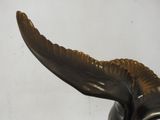 a bronze statue of a bull with horns on it ' s head
