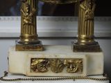 a clock that is sitting on top of a marble table