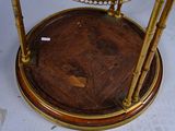 a small table with a glass top and a gold base