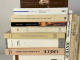 several books are stacked on top of each other on a table