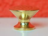 a gold knob on a white table with a red background